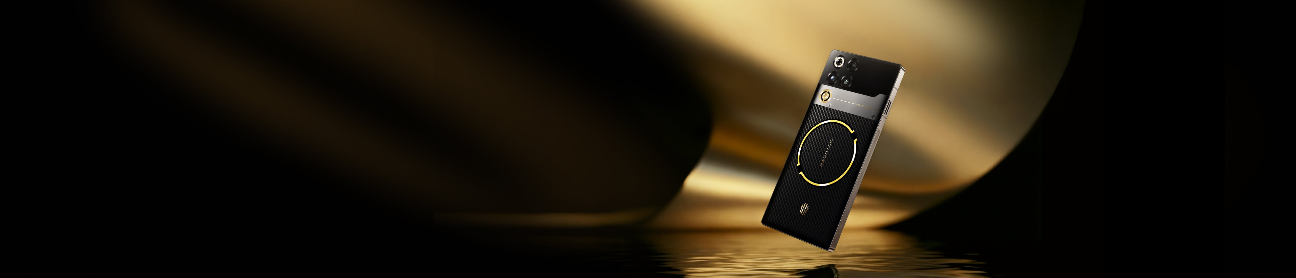 A close-up of a black and gold modern remote control against a dark, softly lit background.